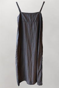 Back of 100% mud silk, black apron style maxi dress with patch pockets